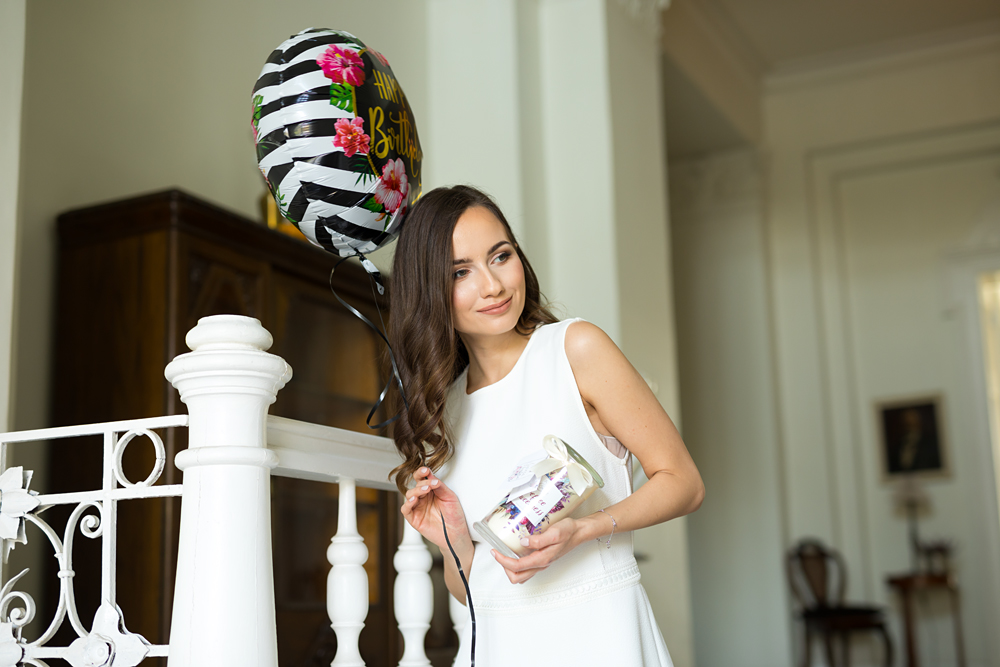 kobieta ze świecą zapachową i urodzinowym balonem
